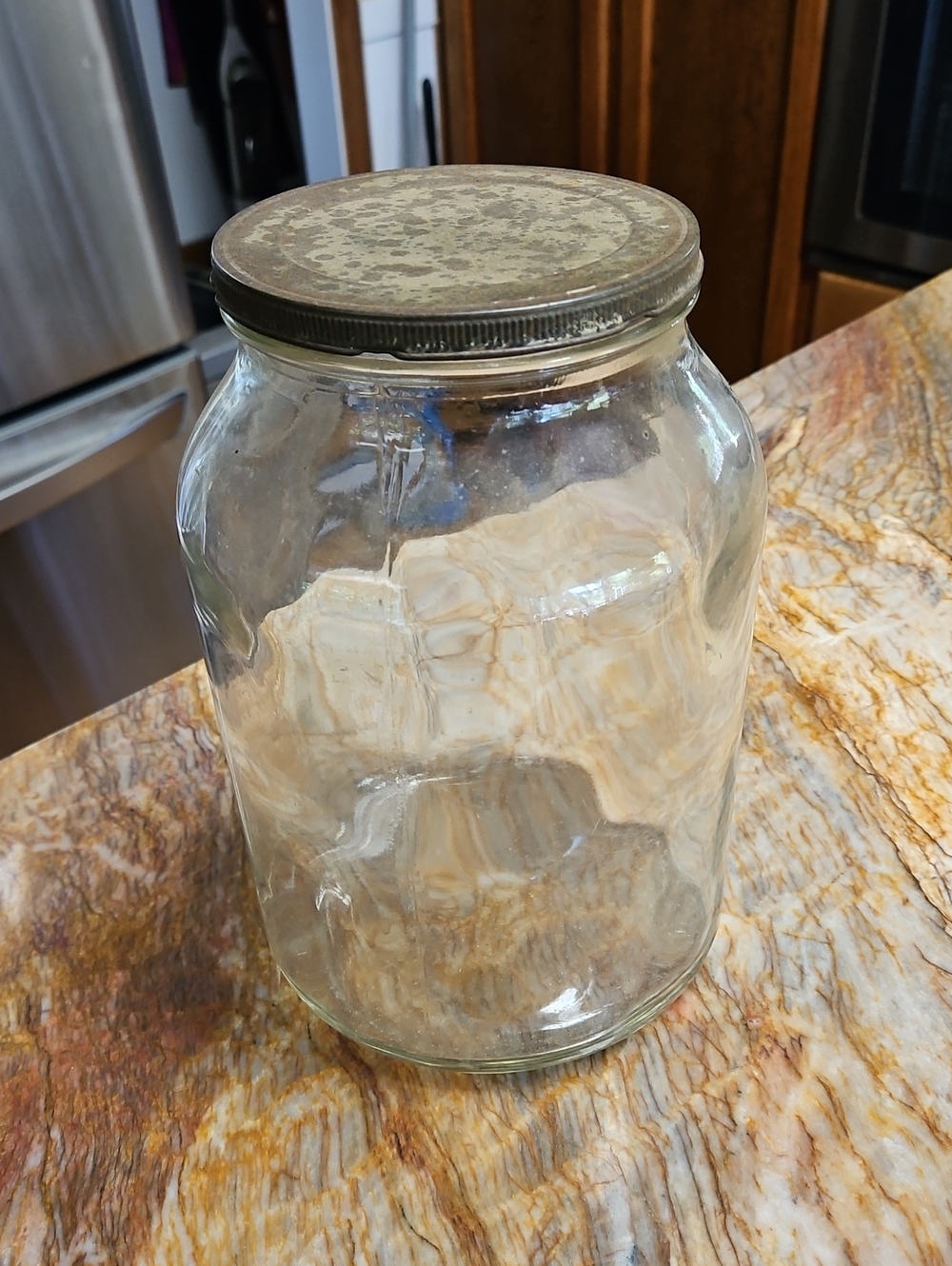 Vintage Duraglas glass jar features a large clear body and a classic textured me